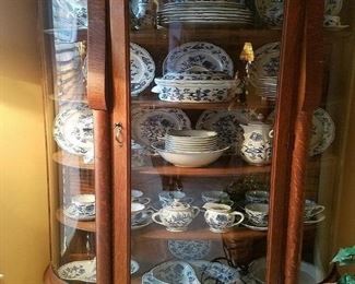Antique oak curio cabinet with curved glass