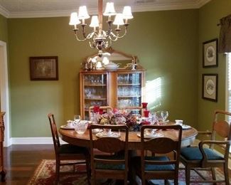 The dining room has several antique pieces including this oak dining table with six dining chairs