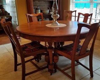 Antique oak dining table and six antique dining chairs