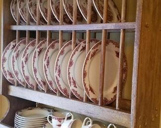 Plate rack filled with 'Les Vendages' by Cambridge Potteries