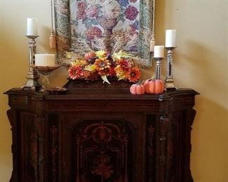 Antique cabinet and hanging tapestry