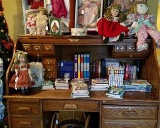 Oak roll top desk and some of the many dolls for sale