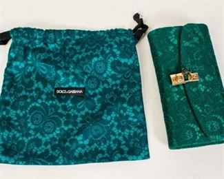 4	Dolce and Gabbana Lace Clutch	Dolce and Gabbana emerald green lace flap front clutch, gold tone turn-lock closure at front and faux emerald embellishment, gold and silver tone chain shoulder strap, satin lining, two interior pockets, includes Dolce compact mirror and authentication card, dust bag, good condition, 4 1/2"H, 9"W, 1 1/2"D
