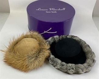 41	Pair of Fur Trimmed Hats and Hatbox	Lot includes Lenore Marshall New York black hat with velvet band and chinchilla trim, 15" W, 22" circumference, good condition; camel wool blend hat with natural gold fox trim, 10"W, 22" circumference, good condition; Lenore Marshall hatbox included.
