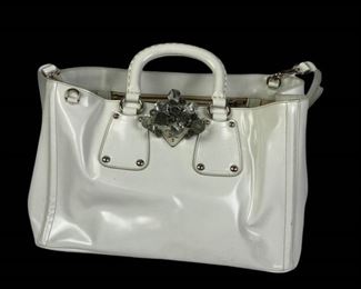 51	Prada White Leather Handbag	Lot includes Prada white leather handbag with crystal cluster embellishment, silver-tone hardware, double handles, removable shoulder strap, leather interior with two zipper pockets, two open pockets, protective feet on base, some scuffs/marks from use, 9"H, 15"W, 8"D.
