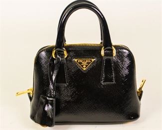 58	Prada Saffiano Mini Galleria Top Handle Bag	Prada black patent saffiano leather bag with gold-tone hardware, rolled top double handles with hanging logo tag, two-way zipper closure, fabric lining with one interior flap pocket, removable, adjustable shoulder strap, authentication card included, very good condition, 5"H, 7"W, 3"D
