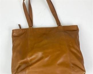 91	Coach Leather Tote	Coach leather tote with double shoulder straps, zippered closure, single zippered interior pocket, some marks and scuffs consistent with use, 12"H, 13 1/2"W, 4 1/2" D
