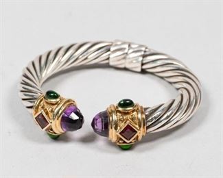 114	David Yurman Sterling & 14k Renaissance Bracelet	David Yurman (American, 20th/21st century). Renaissance design hinged sterling silver cable bracelet, with 14k gold and amethyst, garnet and turquoise ends. Marked on each end 925, 585 and D. Yurman. 2" inside diameter. 43.3 grams including stones.
