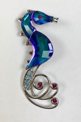 124	Swarovski Celaya Sea Horse Pin	Lot includes Swarovski crystal seahorse pin, swan logo, 3"L
