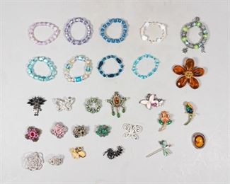 127	Grouping of Brooches and Bracelets	Lot includes multiple costume jewelry brooches and bracelets, cameo pin has silver frame; glass beaded bracelets
