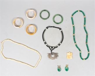 132	Grouping of Natural Hardstone and Jade Jewelry	Lot includes one pair of earrings on gold tone base, five bangles 8" circumference, two carved pendants - one on woven necklace - two hardstone beaded necklaces, 32" circumference
