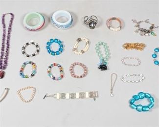 135	Grouping of Costume Bangles and Bracelets	Lot includes evil eye bracelets, Coldwater Creek faux mother-of pearl, Brighton charm bracelet, faux pearl bracelet has sterling clasp, one strand is broken, medical motif gold tone charm bracelet.
