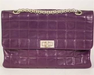 151	Chanel Quilted Reissue Bag	Chanel flap bag, quilted pattern in purple lambskin, antiqued silver-tone hardware, chain link shoulder strap, grosgrain lining with one interior zipper pocket, turn-lock closure at front, some minor wear, marks on bottom of bag, wear around closure, 6"H, 10"W, 2 1/2"D
