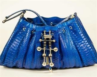 155	Donna Karan Cobalt Blue Python Leather Hobo Bag	Donna Karan cobalt blue python bag with metal accents, single shoulder strap, blue sued lining with one interior slip pocket and one zippered pocket; good condition with light to no wear, 9"H, 15 1/2"W, 4 1/2"D
