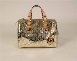 157	Michael Kors Monogram Metallic Gold Bag	Michael Kors monogram leather trimmed handbag, gold ton hardware, gold canvas lining with multiple interior pockets, good condition, 7"H; 10"W; 6"D
