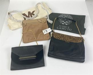 158	Lot of Vince Camuto and Michael Kors Handbags	Lot includes three handbags - Vince Camuto black clutch, gold tone hardware and chain link shoulder strap, flap envelope closure, logo lining with two interior pockets, good condition, 7 1/2 H, 10 1/2 W, 1"D Vince Camuto black leather and dotted camel flap handbag with gold tone accents and hardware, leather and chain link shoulder strap, magnetic clasp, logo fabric lining, multi slip interior pockets and one zippered interior pocket, tag still attached, includes dust bag, excellent condition, 10"H, 12"W, 3 1/2"D; Michael Kors crossbody Riley bag in champagne nylon, gold tone hardware, zippered closure, adjustable buckle shoulder strap, multi slip interior pockets, one zippered interior pocket, one zippered outside pocket, tags still attached, good condition, 10"H, 10 1/2"W, 1"D
