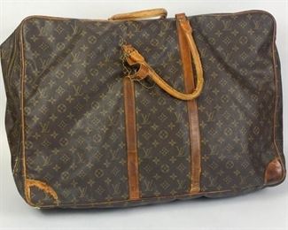 196	Louis Vuitton Luggage Sirius, Monogram Canvas	Lot includes vintage Louis Vuitton zippered suitcase, well-worn, stitching and rivet missing at one handle, scuffing, creasing, marks, worn leather handles, interior has, one small hole, 17"H, 24"L, 7"D.
