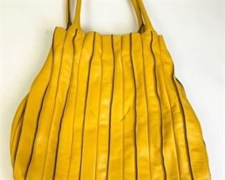 204	Lupo Yellow Abanico Leather Bag	Made in Spain, double handles hobo bag with fabric lining, one zipper pocket with embossed Lupo logo. Pen marks on side of bag, on handle and interior. 17.5" l x 17.5" w x 3.5" d
