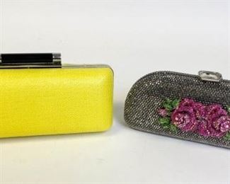 218	Diane Von Furstenberg and Rose Iris Lane Clutches	Two small purses; yellow Diane Von Furstenberg framed hard-shell Tonda clutch with detachable chain, enamel bar hinge clasp, 8.25" l x 4" w x 2.5" d - Strap Drop 20" marks and wear inside, outside condition good; Rhinestone rose embellished Iris Lane framed hard shell clutch with detachable silver tone chain, missing top gem, 8" l x 3.25" w x 2" d - Strap Drop 24", some staining and marks on interior
