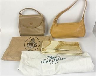 221	Lot of Three Designer Handbags	Lot includes Mark Cross taupe pebbled leather handbag, flap magnetic closure, gold tone hardware, protective metal feet, three interior compartments, includes dust bag, marks and minor wear consistent with use, 7"H, 9"W, 3"D; Longchamp leather handbag with single shoulder strap, zippered closure, two interior pockets, includes dust bag, some scratches and marks from wear, 5"H, 11"W, 3 1/2"D; Carlos Falchi leather clutch, snakeskin patchwork exterior, gold tone snap closure, leather interior and single pocket, some pen marks and creases consistent with use, good condition, 7"H, 12"W, 2"D
