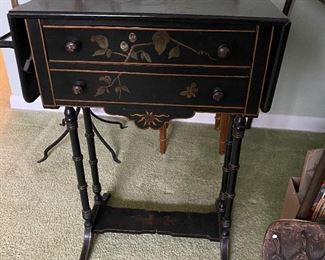 Vintage drop-side table with drawers and painted motif.