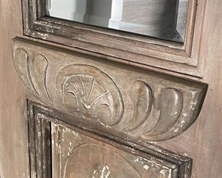 PAIR ANTIQUE CARVED DOOR MIRRORS | Originally sold by Pottery Barn; mango and mahogany wood with a hand-carved and hand-painted distressed finish made from an antique door, with beveled mirror glass; h. 98 x 22 in. 