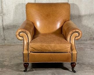 BROOKLYN LEATHER ARMCHAIR | By Pottery Barn, made to order Burnished Bourbon leather finish, Edwardian style chair with pleated roll arms outlined with nailheads, caster feet in an espresso finish; overall h. 35 x w. 37 x d. 36 in.; original price $1,399 
