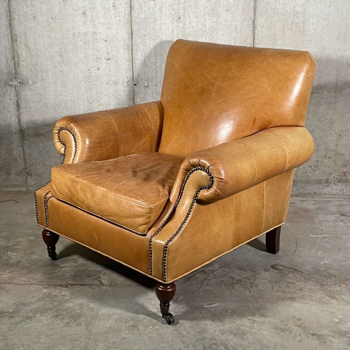 BROOKLYN LEATHER ARMCHAIR | By Pottery Barn, made to order Burnished Bourbon leather finish, Edwardian style chair with pleated roll arms outlined with nailheads, caster feet in an espresso finish; overall h. 35 x w. 37 x d. 36 in.; original price $1,399 