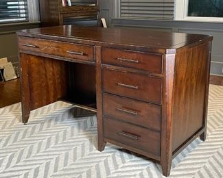 OFFICE DESK | Art deco style desk of nicely figured wood, with thin center drawer flanked by four side drawers; h. 31 x w. 52 x d. 24 in. [with surface wear as pictured]