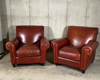 PAIR LARGE LEATHER CHAIRS | Rapallo Leather Company; pair of hardwood frame brown leather chairs complete with foot rest ottomans, four dark brown block feet on each piece; 38 x 42 x 42 in.; bottom lining loose on one foot rest 