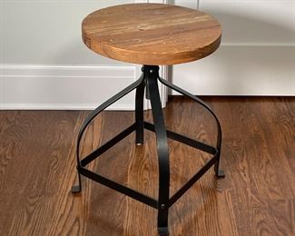 INDUSTRIAL LOW SWIVEL STOOL | Round wood block seat with natural finish atop a curved industrial black four-legged metal frame; h. 21 x dia. 15 in. 