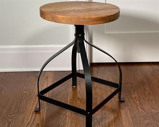 INDUSTRIAL LOW SWIVEL STOOL | Round wood block seat with natural finish atop a curved industrial black four-legged metal frame; h. 21 x dia. 15 in. 