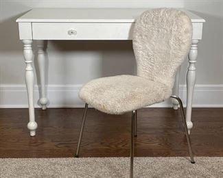 POTTERY BARN DESK AND CHAIR | A white-painted wood desk or vanity table with a single drawer with two glass pulls (h. 30 x w. 43-1/2 x 22 in.) and round "Ivory Fur" upholstered desk chair (32 x 17 x 21 in.), both from Pottery Barn Kids