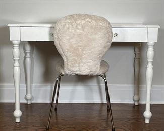POTTERY BARN DESK AND CHAIR | A white-painted wood desk or vanity table with a single drawer with two glass pulls (h. 30 x w. 43-1/2 x 22 in.) and round "Ivory Fur" upholstered desk chair (32 x 17 x 21 in.), both from Pottery Barn Kids