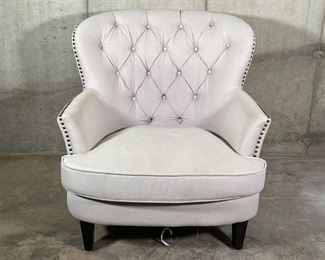 WINGED CLUB CHAIR | Cream colored fabric club chair with tufted backrest and tacked side accents, elevated on four square tapering legs; 33 x 32 x 36 in. [bottom lining torn] 