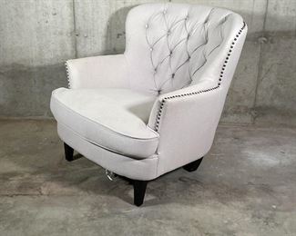 WINGED CLUB CHAIR | Cream colored fabric club chair with tufted backrest and tacked side accents, elevated on four square tapering legs; 33 x 32 x 36 in. [bottom lining torn] 