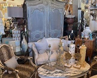 Painted armoire, vintage marble top coffee table, Louis XV settee in linen, pair vintage Italian armchairs in leopard, and more.
