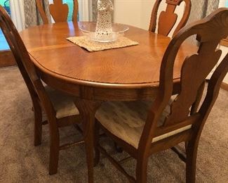 Oak dining table with six chairs