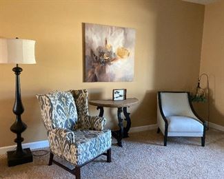 Modern upholstered chairs, side table, floor lamp, artwork