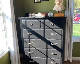 Black dresser, doll