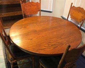 This oak table/chair set is available for presale.  $450 for the 5 piece set. There is one table leaf with this table