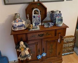 C. 1950's diminutive cupboard made by American Republic - Tell City Furniture. In excellent condition with original stenciling and finish. Accessories are just a sampling of antique and collectible Delft and Blue Onion patterns.