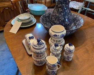 Set of four maple Ethan Allan Windsor style chairs - two with arms and two without. Oval maple table, unknown maker, with two extension leaves. Very nice size vintage maple Hitchcock style bench with stenciling. Vintage Pyrex casserole in aqua with decorations and hard to find rack. More vintage chintz and blue onion pattern items.