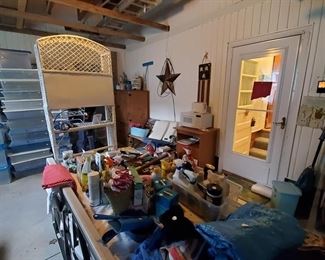 We made it to the garage! Lots of items. In back corner is a storage cabinet and also a really nice bench - iron frame with wood back and seat; rattan storage item.