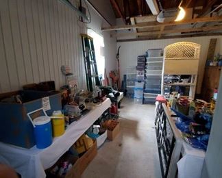 More in garage. In back are several yard tools- blower, gas powered trimmer, another stack of totes, etc.