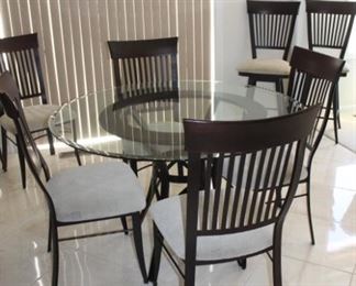 Beautiful glass-top table with 6 chairs   48” Diameter