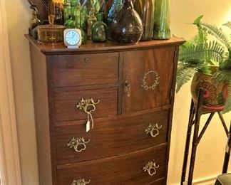 Antique chest; more colored bottles
