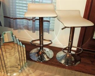 Contemporary leather and chrome bar chairs, mirror decor