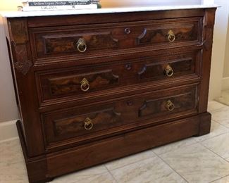 $600.00.  Authentic 19th century Eastlake burled walnut three drawer marble top chest with brass ring pulls; beautiful white Carrera marble with ogee ledge; 45” wide by 20” deep by 32” high. 