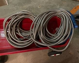 Two metal garden hoses